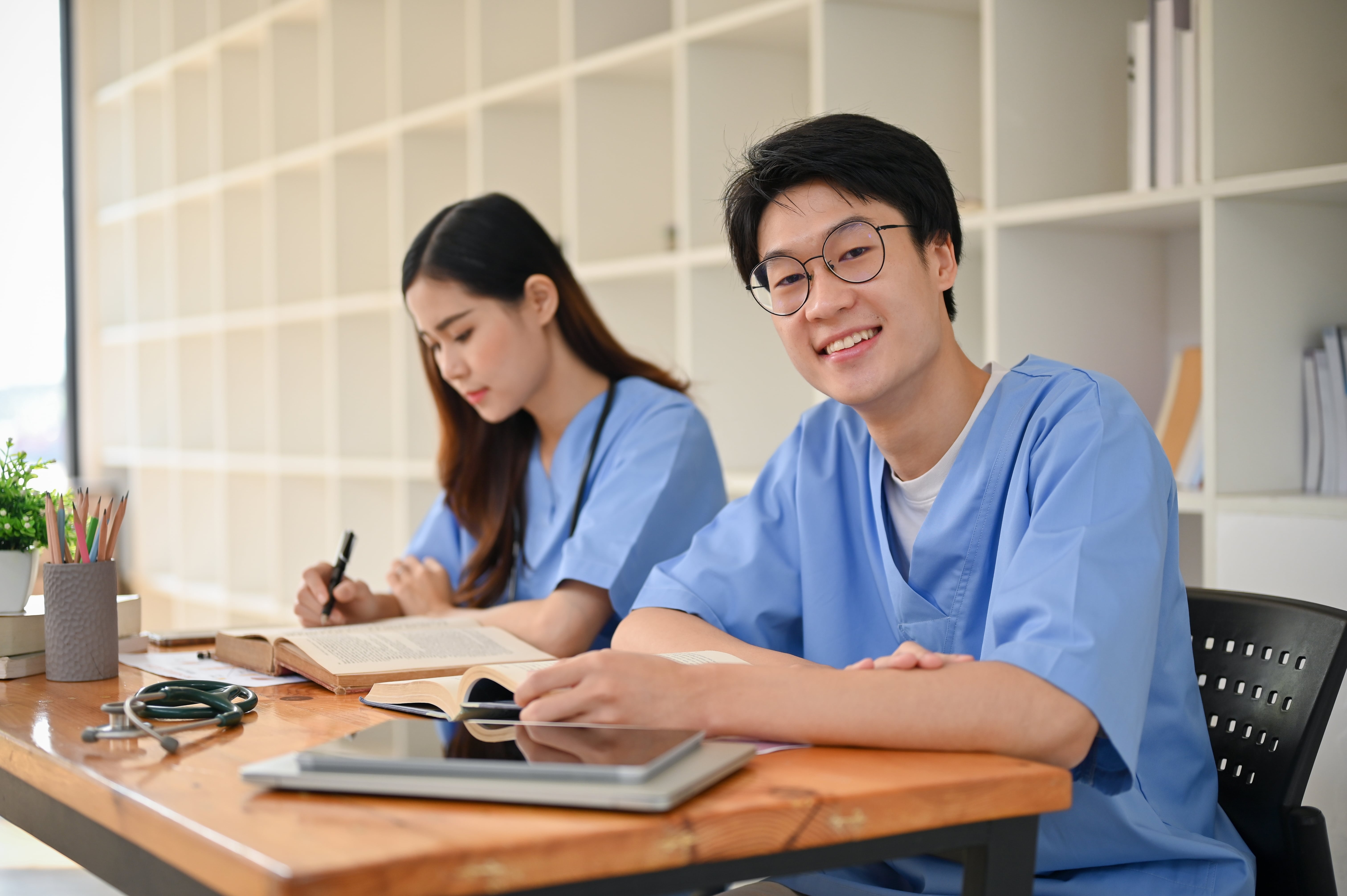 Two smiling medical students prepare for the ABA ADVANCED Exam