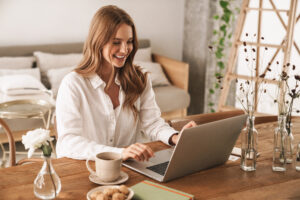 Caucasian woman on her laptop in her home office, earning online internal medicine CME credits.