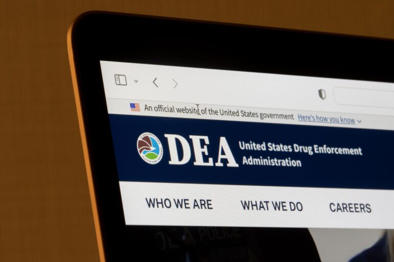 DEA website on the laptop tells physicians more about the DEA MATE Act training requirements.